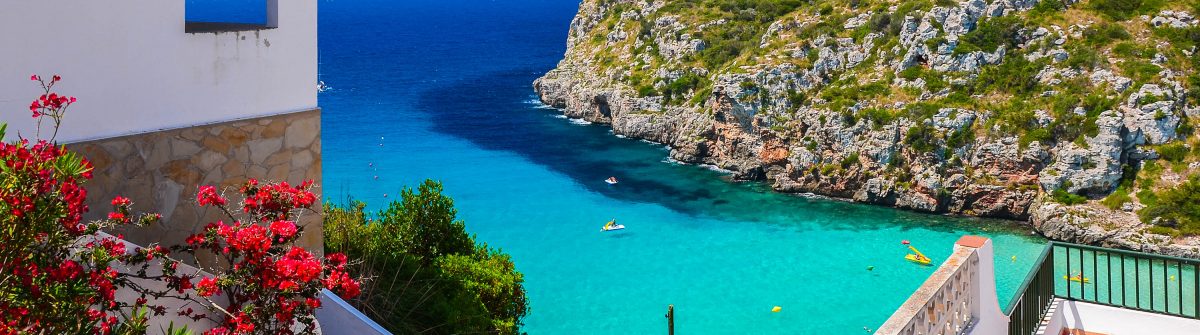 Holiday villa overlooking Cala Porter Menorca island Spain shutterstock_567838465 2 1200x335